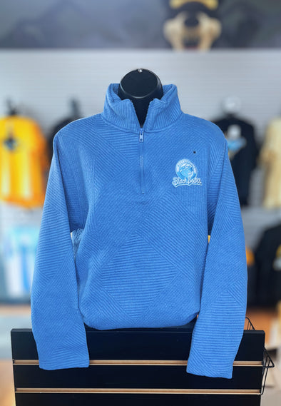 Blue pullover with a logo on a mannequin against a blurred background